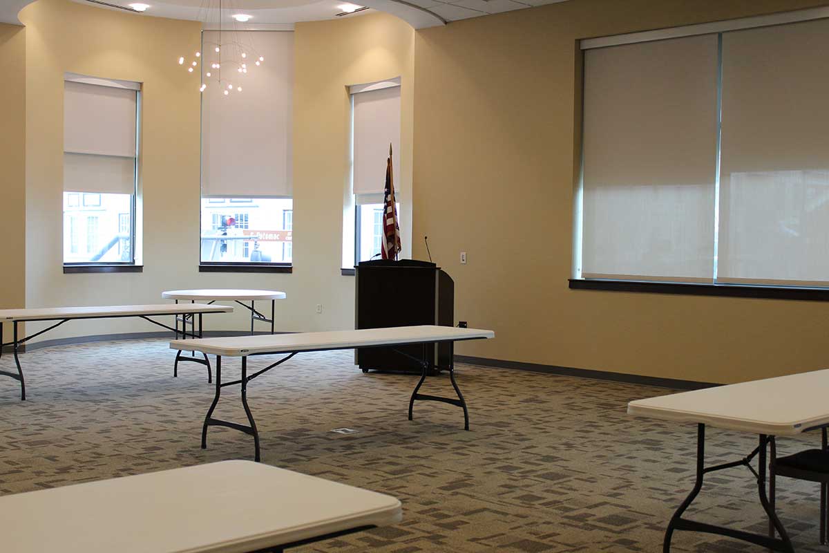 Interior shot of the Combined Community Room 308/309 with tables and whiteboard