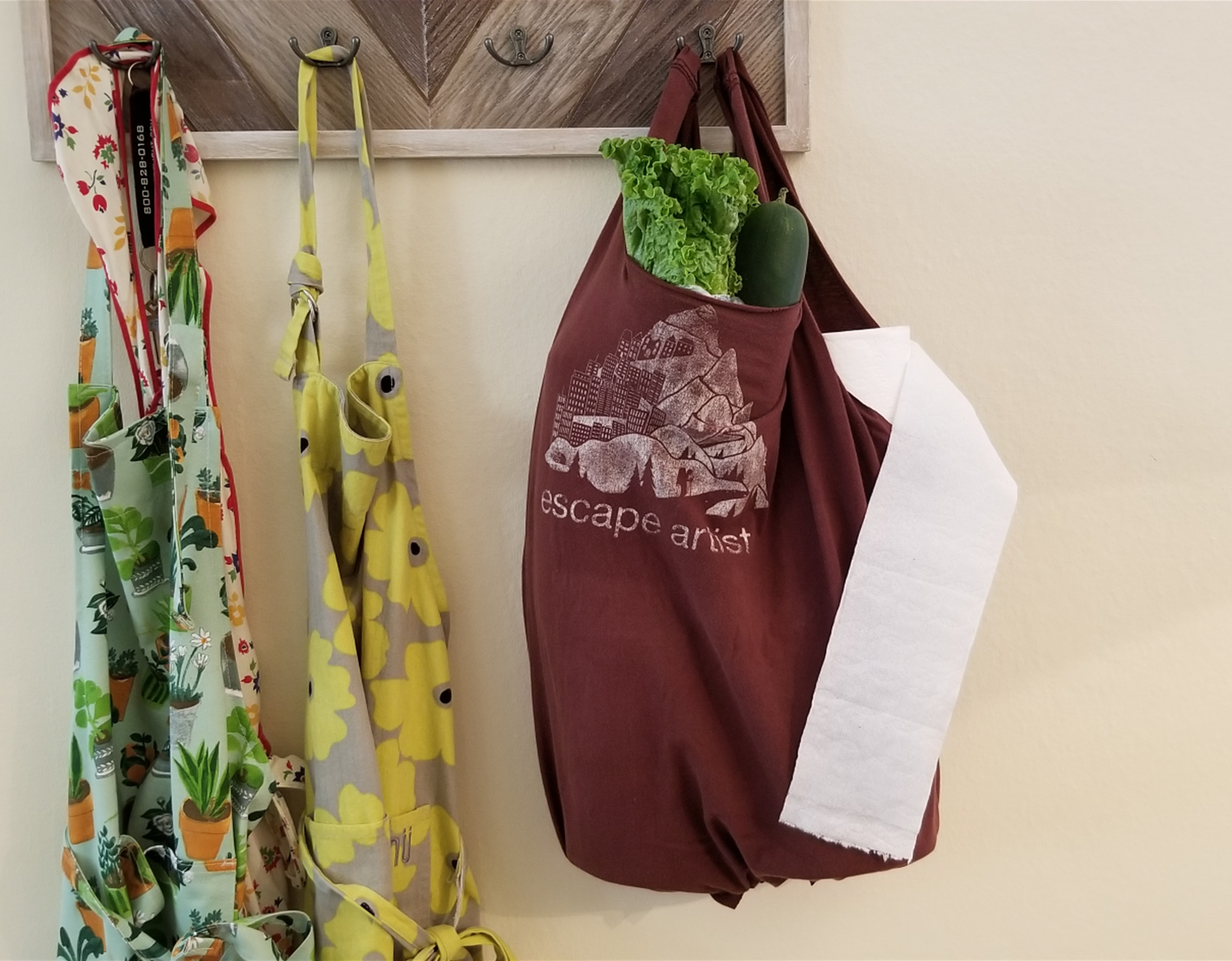A finished t-shirt tote bag filled with vegetables and TP.