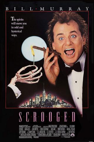 A man faces forward holding a cigar, while a skeletal hand holds a match to the cigar; both are backlit by a full moon over a cityscape