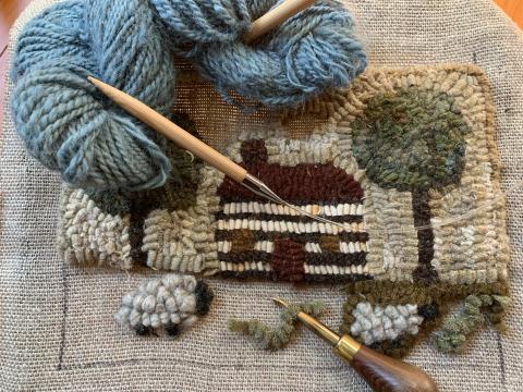Picture of a hooked rug and knitting 