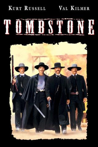 Four men in a line in Western attire holding guns