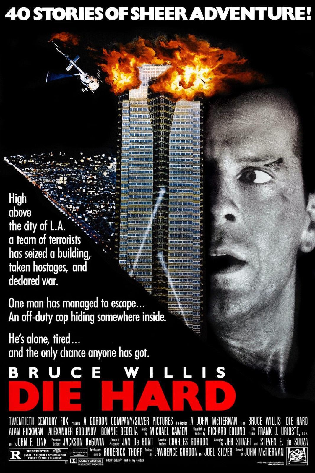 A man's face is half-lit, as he looks out of the corner of his eye at two skyscrapers, the top of which is exploding